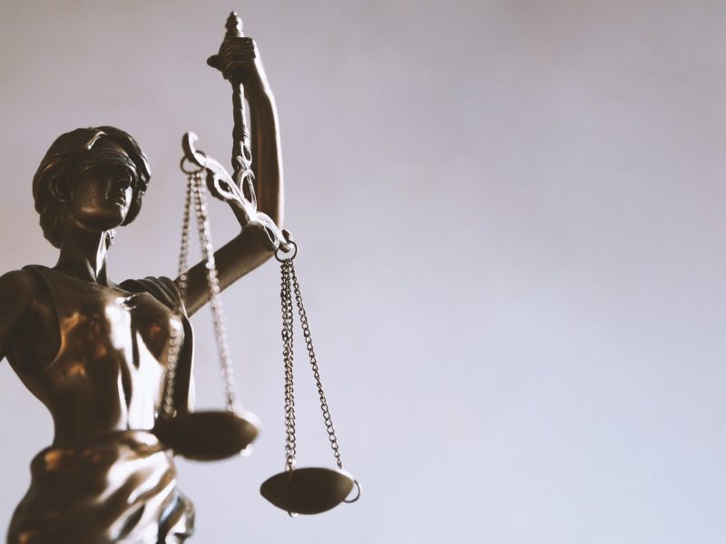 Lady Justice or Justitia statue with blindfold and scales is a symbol for law and legal concepts.